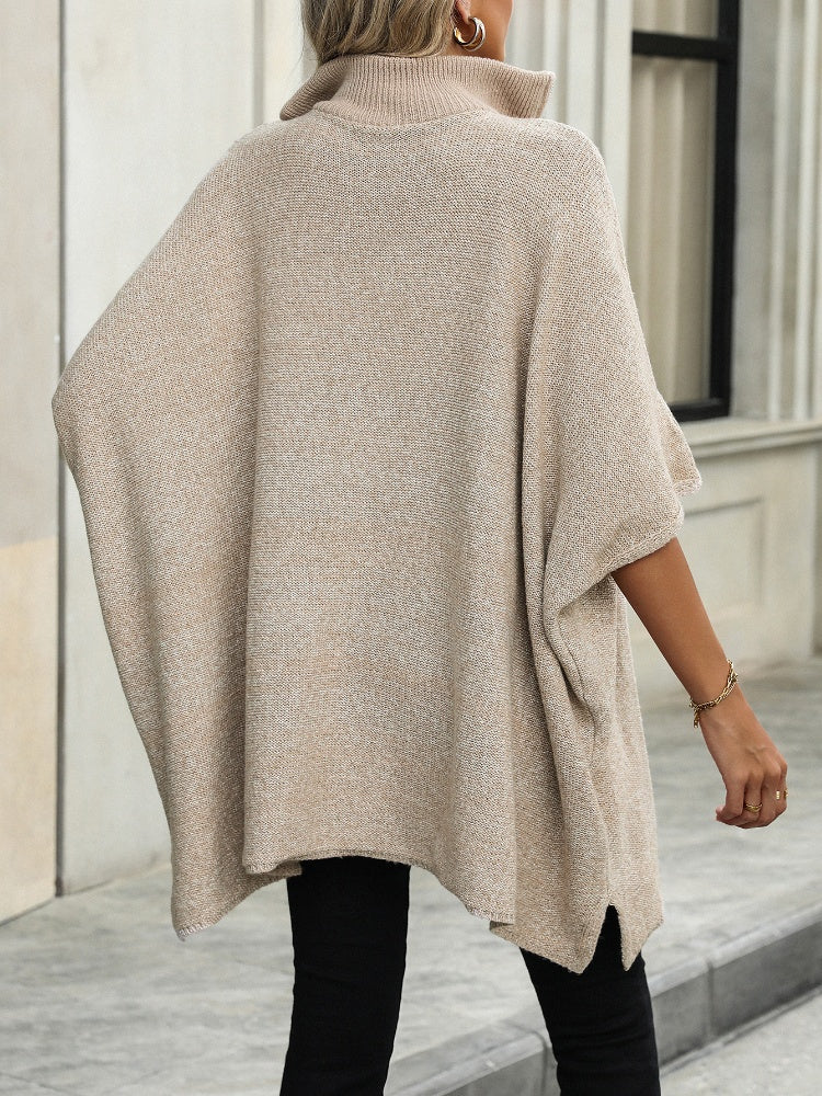 Apricot knit zip-neck poncho with asymmetrical hem and mock neck.