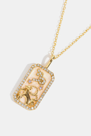 14K gold-plated Capricorn zodiac sign crystal pendant necklace with pink enamel and rhinestones.