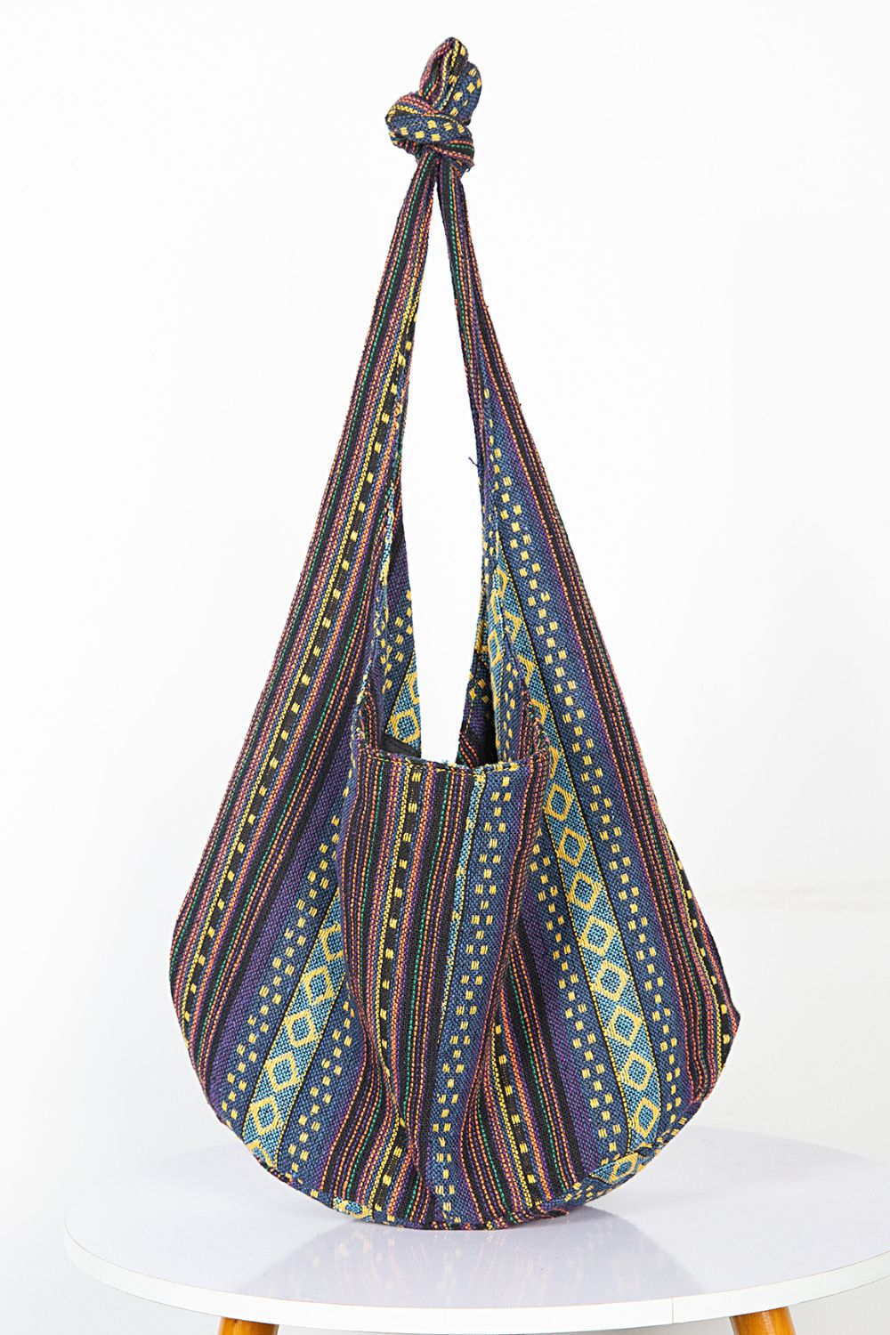 Tribal weave shoulder bag with geometric patterns in blue, purple, and yellow.