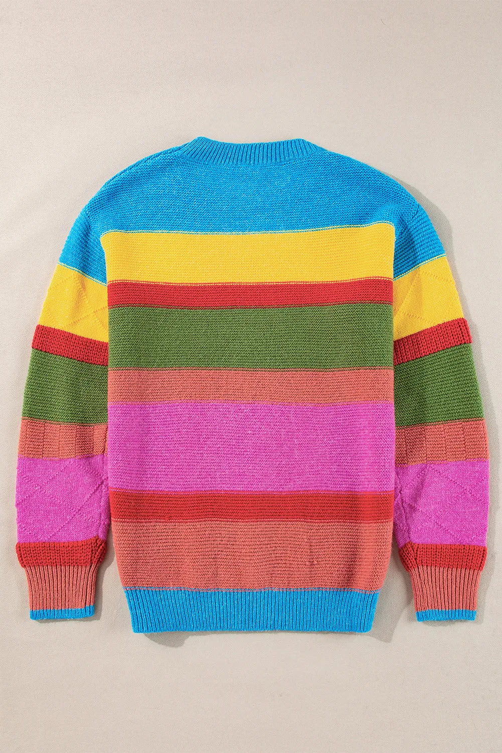 Rainbow stripe knit crewneck sweater with crew neckline and long sleeves.