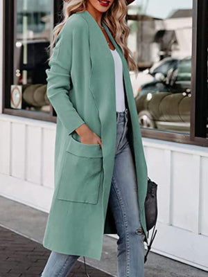 Turquoise open-front duster cardigan with pockets, styled with jeans.