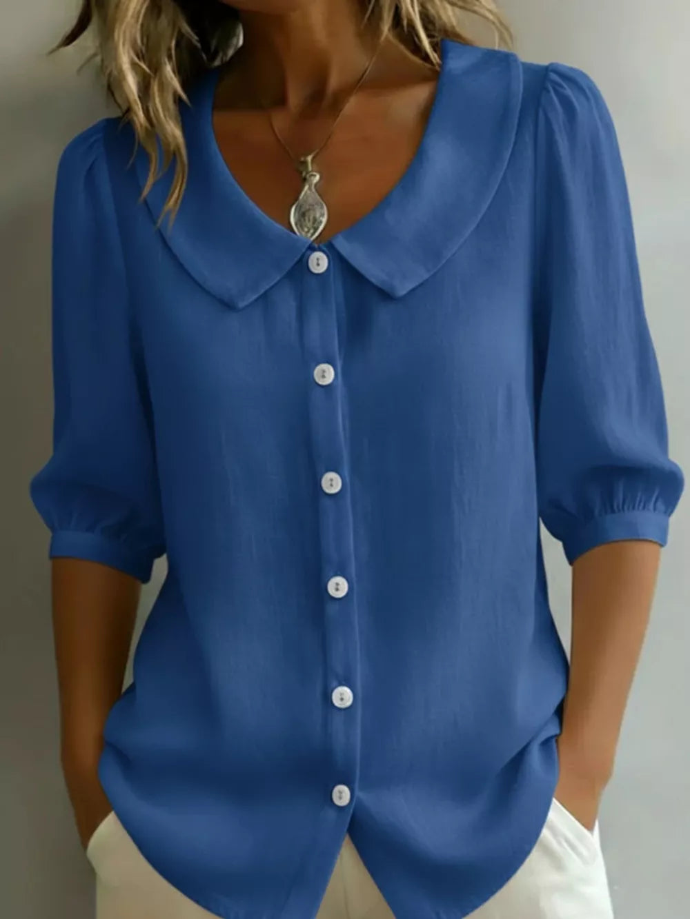 Royal blue button-down shirt with Peter Pan collar and puff sleeves.