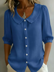Royal blue button-down shirt with Peter Pan collar and puff sleeves.