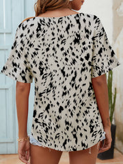 Dalmatian print relaxed notch neck blouse in beige with short sleeves.
