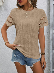 Camel eyelet blouse with scalloped short sleeves and round neckline.