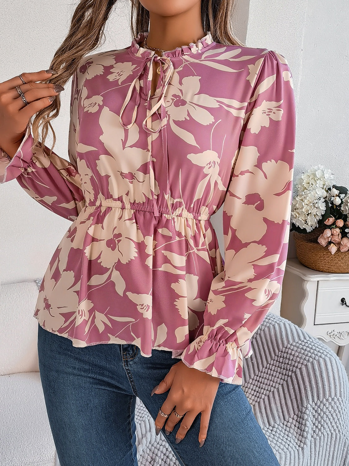 Floral peplum blouse with tie neck and ruffled cuffs in pink purple