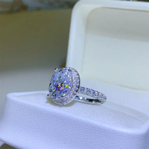Silver oval halo moissanite engagement ring with pave band