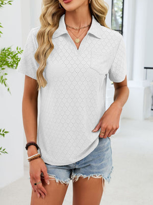 White eyelet polo blouse with short sleeves and a chest pocket.