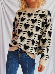 Geometric heart jacquard knit jumper in tan with black hearts and stripes pattern, crew neck, long sleeves.
