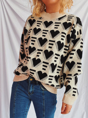 Geometric heart jacquard knit jumper in tan with black hearts and stripes pattern, crew neck, long sleeves.