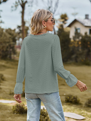 Sage green textured blouse with lace trim neckline and flared cuffs