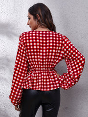 Red gingham peplum blouse with gathered waist and balloon sleeves.
