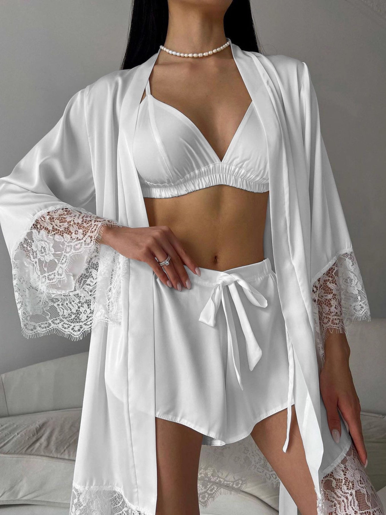 White lace trim three-piece loungewear set with bralette, shorts, and robe.