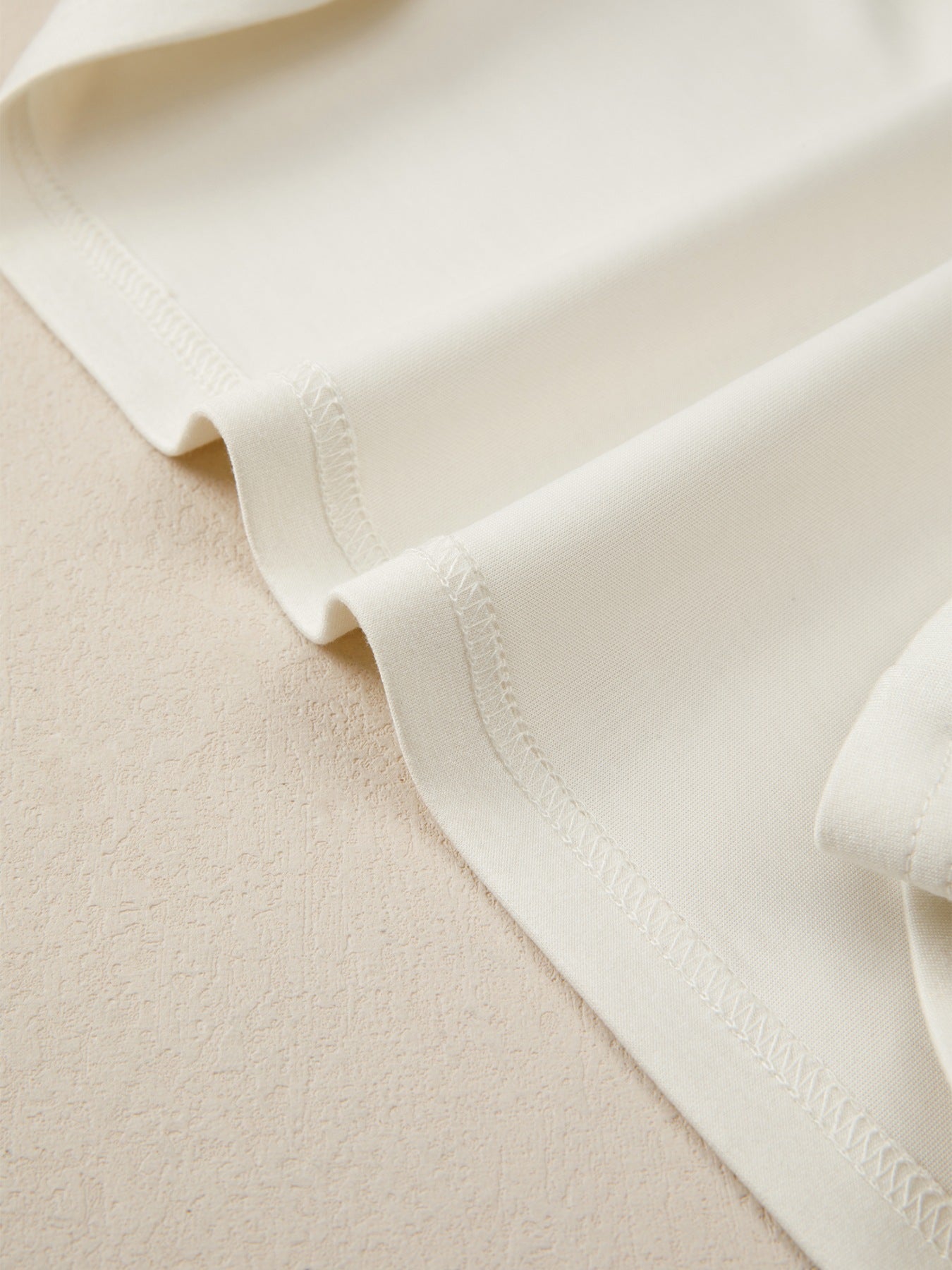 Beige buttoned blouse with visible stitching detail