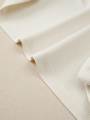 Beige buttoned blouse with visible stitching detail