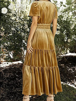 Velvet maxi dress in mustard yellow with ruched waist and tiered skirt.