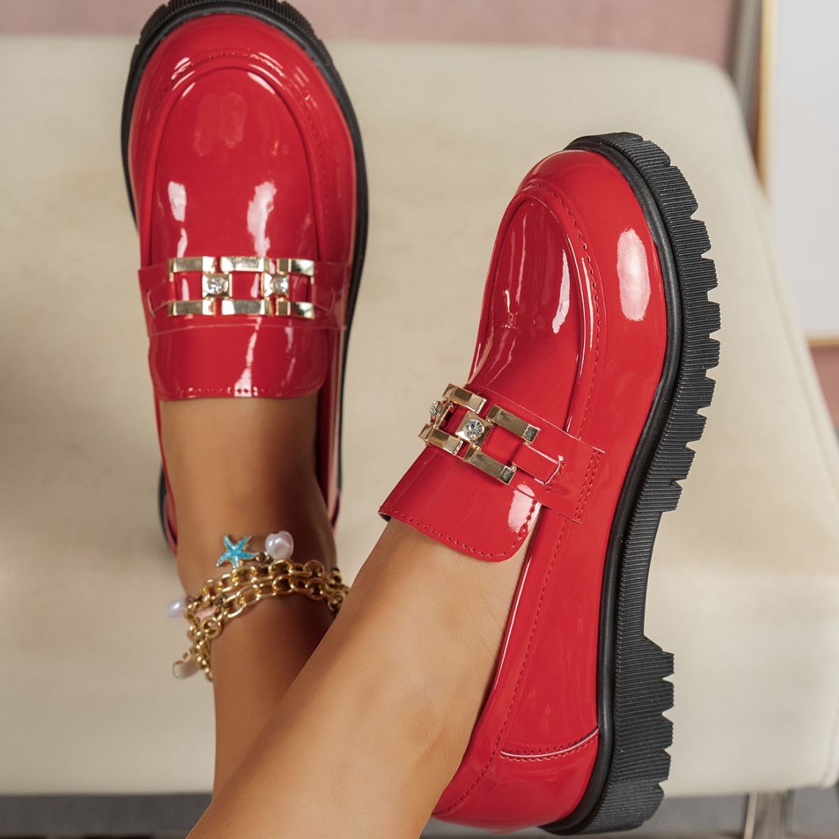 Red patent chunky loafers with buckle accent and crystal details.