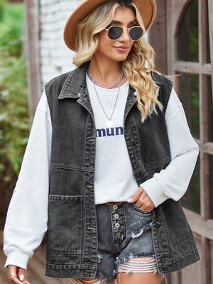 Black oversized denim utility vest with button front and chest pockets.