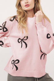 Bow Motif Knit Crewneck Sweater in Blush Pink with black bow pattern, crewneck, long sleeves.