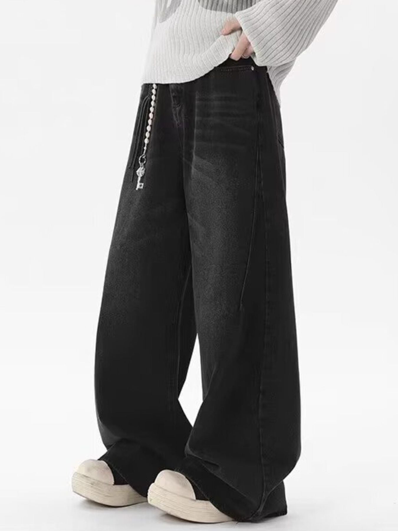 Men's black wide-leg jeans, 100% cotton, with vintage wash and key charm detail.