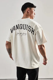 Oversized white graphic tee with "Vanquish" back print and script detail.