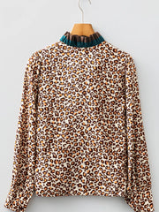 Leopard print button-down shirt with a frilled mock neck and long sleeves.