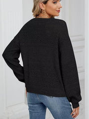 Black eyelet knit pullover sweater with V-neck and long sleeves.