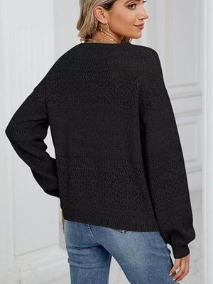 Black eyelet knit pullover sweater with V-neck and long sleeves.