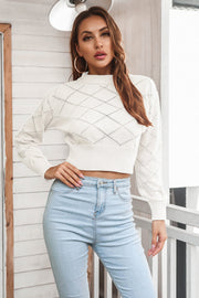 White diamond knit cropped sweater with mock neck and long sleeves.