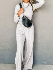 Light gray turtleneck loungewear set with drawstring pants and a quilted fanny pack.