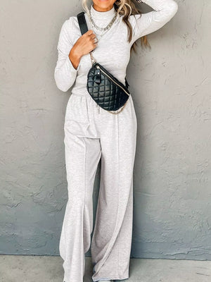 Light gray turtleneck loungewear set with drawstring pants and a quilted fanny pack.