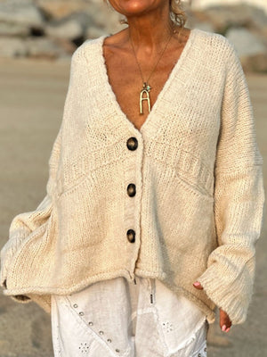 Beige bouclé oversized button-down cardigan with V-neck, pockets, and textured knit.