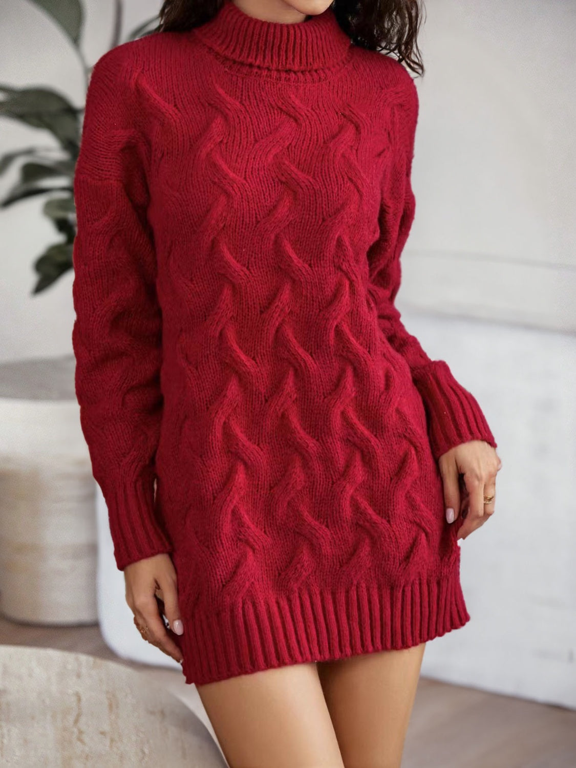 Burgundy cable knit turtleneck mini dress with long sleeves and ribbed trim.