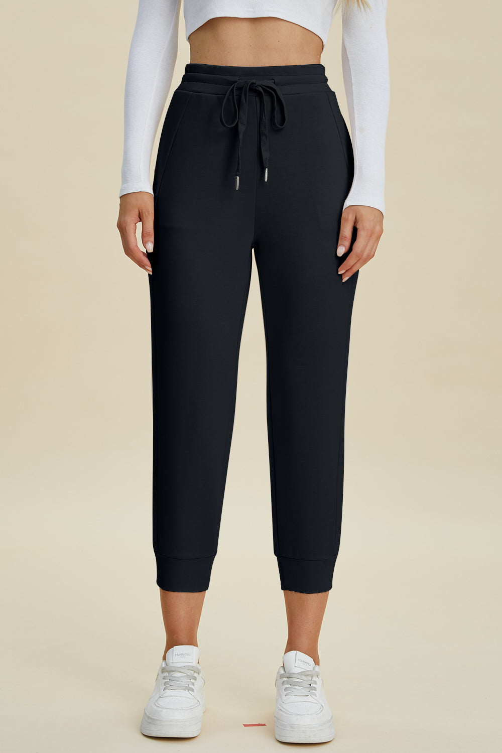 Black joggers with drawstring waist and cuffed ankles.