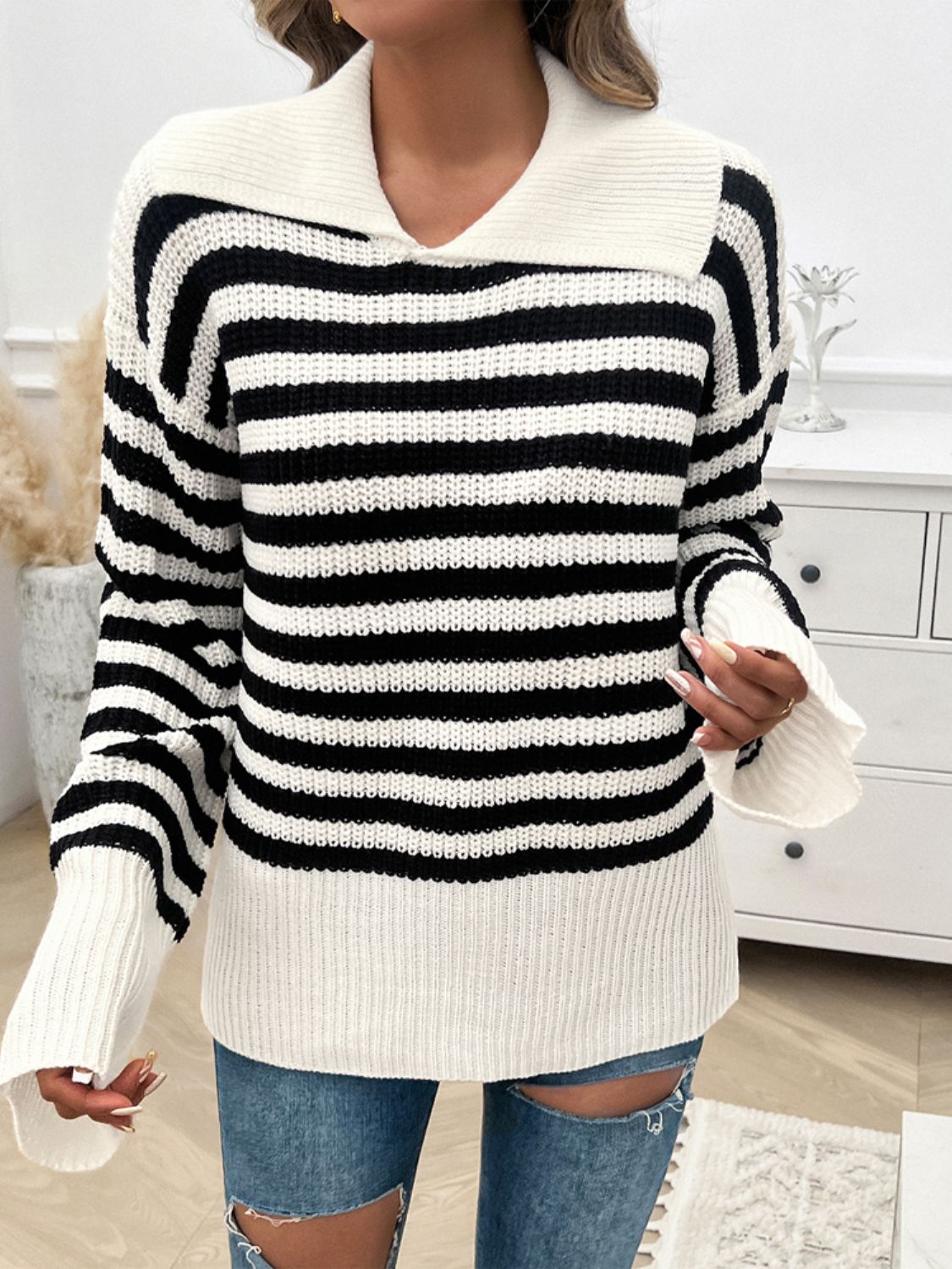 Black and white stripe knit pullover sweater with wide collar and bell sleeves.