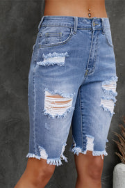 Light wash denim Bermuda shorts with ripped knees and frayed hem