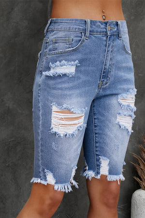 Light wash denim Bermuda shorts with ripped knees and frayed hem