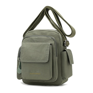 Green lightweight nylon crossbody bag with multiple pockets and adjustable strap.