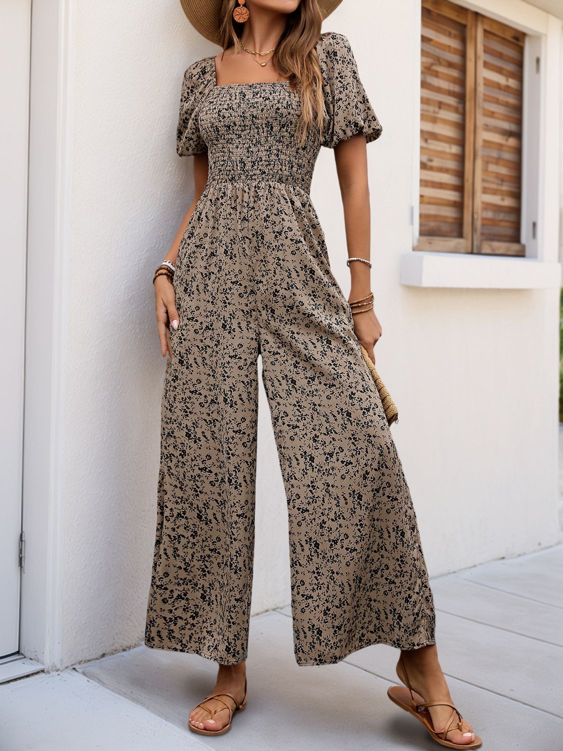 Taupe floral smocked bodice palazzo jumpsuit with square neckline and puff sleeves.