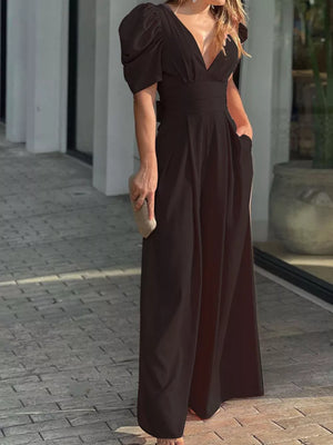 Black puff sleeve romper with deep V-neck and cinched waist.