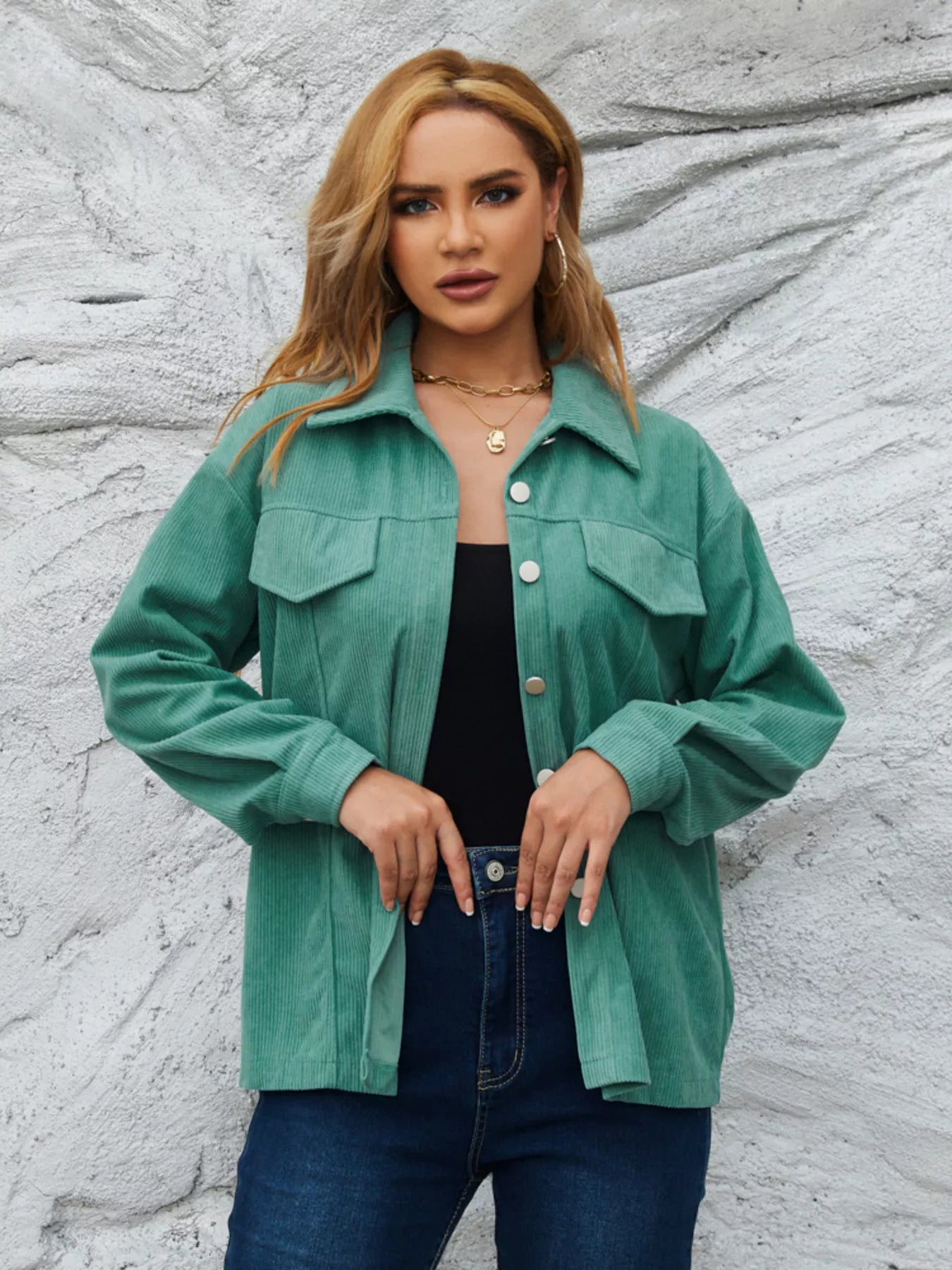 Textured corduroy button-up jacket in Peacock Green with two chest pockets and silver buttons.