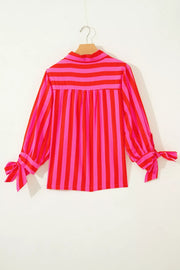 Vibrant puff sleeve stripe shirt with tie cuffs in pink and red cotton blend.