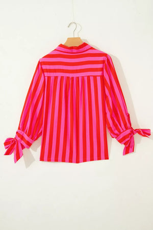Vibrant puff sleeve stripe shirt with tie cuffs in pink and red cotton blend.