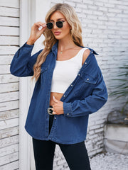 Oversized dark blue denim utility shirt with button-down front and chest pockets.
