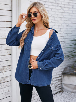 Oversized dark blue denim utility shirt with button-down front and chest pockets.