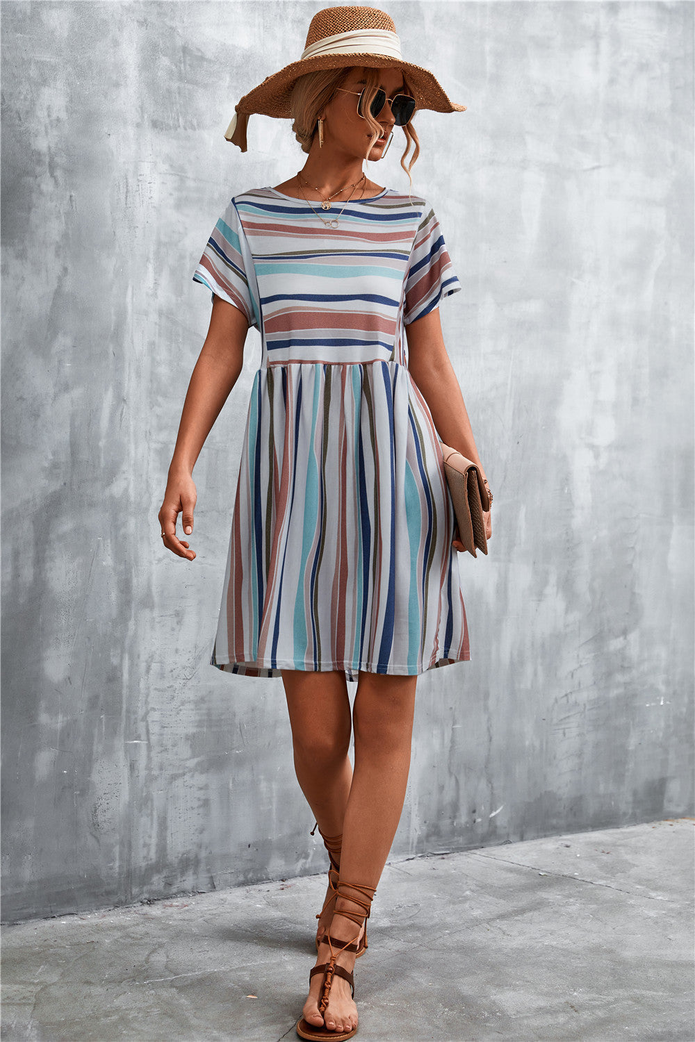 Striped yoke-seam trapeze dress with short sleeves and a trapeze skirt in multi-color stripes.
