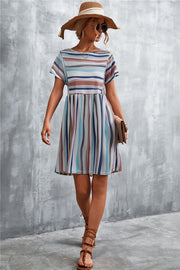 Striped yoke-seam trapeze dress with short sleeves and a trapeze skirt in multi-color stripes.