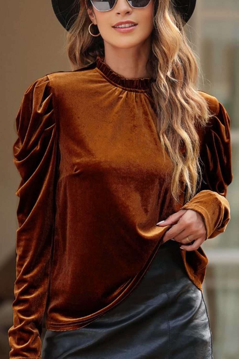 Brown velvet blouse with gathered puff sleeves and a mock neck.