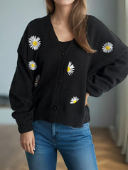 Black acrylic oversized knit cardigan with embroidered daisies, V-neck, button front.