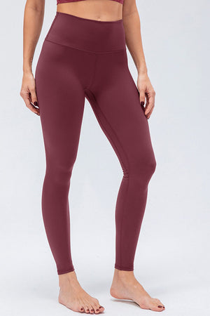 Burgundy high-rise performance leggings with a seamless waistband and full length.